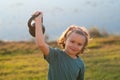 Child boy raising a kettlebell. Cute child training with dumbbells. Kids fitness. Kid boy exercising with dumbbells Royalty Free Stock Photo