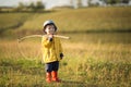 Child boy ready for fishing. Cute little boy in hat holding big fishing net at the ready. Royalty Free Stock Photo