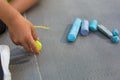 Child boy hand drawing with outdoor large size colorful chalk sidewalk