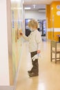 Child, boy, sitting in the waiting room in emergency, waiting for examination Royalty Free Stock Photo