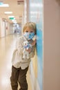 Child, boy, sitting in the waiting room in emergency, waiting for examination Royalty Free Stock Photo