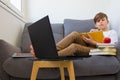 Child boy studying online at home with books and laptop Royalty Free Stock Photo