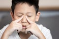 Child boy suffering chronic Rhinosinusitis,Rhinitis or acute Sinusitis,pain in nasal cavity,nose bridge sore,aching eye socket, Royalty Free Stock Photo