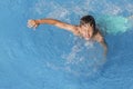 Child boy swim in blue water of hotel swimming pool at summer resort. Kids fun leisure activity. Water sports, vacation Royalty Free Stock Photo