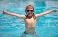 Child boy swim in swimming pool. Children play in tropical resort. Family beach vacation. Kids learn to swim. Royalty Free Stock Photo