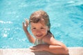 Child boy swim in swimming pool. Happy little kid boy playing with in outdoor swimming pool on hot summer day. Kids Royalty Free Stock Photo