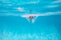 Child boy swim under water in sea. Kid swimming in pool underwater. Happy boy swims in sea underwater, active kid Royalty Free Stock Photo