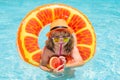 Child boy in swimming pool. Little kid boy having fun in the pool. Outdoor summer activity for children. Child in Royalty Free Stock Photo