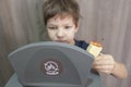 Child boy throwing apple core to waste bin for organic at home