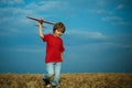 Child boy toddler playing with toy airplane and dreaming future. Active children concept. Concept kids and nature. Happy Royalty Free Stock Photo