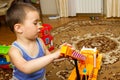 Child boy toddler playing with toy car indoors Royalty Free Stock Photo