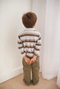 Child boy, trouble and time out for bad behaviour, discipline and parenting in family home. Punishment, small kid or son