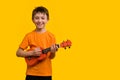 Child boy with ukulele in studio Royalty Free Stock Photo