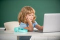 Child boy using a laptop computer at school. Education, school, technology and children concept. Royalty Free Stock Photo