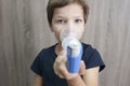 Child boy using medical spray for breath