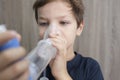 Child boy using medical spray for breath