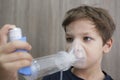 Child boy using medical spray for breath