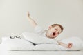 child boy wakes up and stretching on his comfortable bed in morning, Health care and good morning world concept Royalty Free Stock Photo