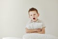 child boy wakes up and stretching on his comfortable bed in morning, Health care and good morning world concept Royalty Free Stock Photo