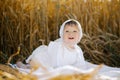 A child boy in white clothes is relaxing in the fresh air in a field Royalty Free Stock Photo