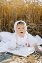 A child boy in white clothes is relaxing in the fresh air in a field Royalty Free Stock Photo