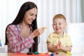 Child boy and woman play colorful clay toy at nursery or kindergarten Royalty Free Stock Photo