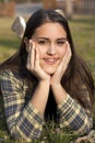 Child with braces smiling in a field