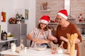 Child breaking eggs in bowl making homemade traditional cookies dough