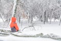 Child and broke down tree of snow. Child sitting over the trunk Royalty Free Stock Photo