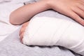 A child broken arm in plaster case, hand injury because of accident, forearm bones fracture