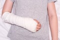 A child broken arm in plaster case, hand injury because of accident, forearm bones fracture