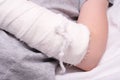 A child broken arm in plaster case, hand injury because of accident, forearm bones fracture