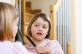 Child brushing hair Royalty Free Stock Photo