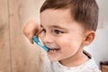 Child brushing teeth. Kids tooth brush and paste. Little funny baby boy brushing his teeth in modern bathroom on sunny Royalty Free Stock Photo