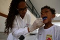 Child brushing tooth during social project