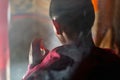 Child buddhist monk praying in monastery, Tibet