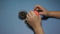 Child bugging in the hands of a soft ball on the blue background.