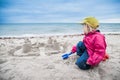 Child building sand castle near the ocean Royalty Free Stock Photo