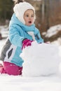 Child building snowman. Royalty Free Stock Photo