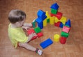The child builds a castle out of plastic designer. Game with the designer.