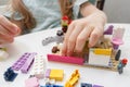 Child builds with constructor bricks, plays with toys