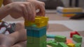 The child builds an imaginary tower of wooden multi-colored cubes Royalty Free Stock Photo
