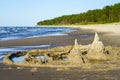 A child built a sand castle on the seashore
