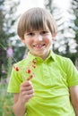 A child with a bunch of wild strawberries Royalty Free Stock Photo