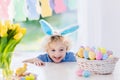 Child with bunny ears on Easter egg hunt Royalty Free Stock Photo