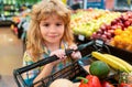 Child buying fruit in supermarket. Kid buy fresh vegetable in grocery store. Kids in shop, healthy food. Healthy kids Royalty Free Stock Photo