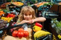 Child buying fruit in supermarket. Kid buy fresh vegetable in grocery store. Kids in shop, healthy food. Shopping cart Royalty Free Stock Photo