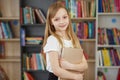 Child buys books in bookstore for learning or reading. Girl choosing book in school library Royalty Free Stock Photo