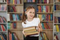 Child buys books in bookstore for learning or reading. Girl choosing book in school library Royalty Free Stock Photo