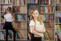 Child buys books in bookstore for learning or reading. Girl choosing book in school library Royalty Free Stock Photo